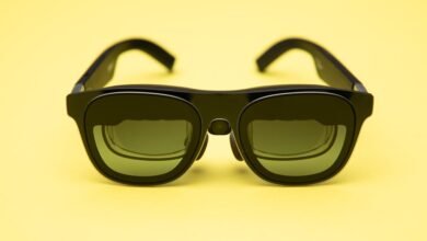 Black XREAL Air 1S AR glasses on a bright yellow background.