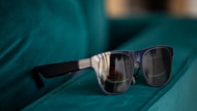 XREAL Air 1S AR glasses on a teal velvet surface, close-up.