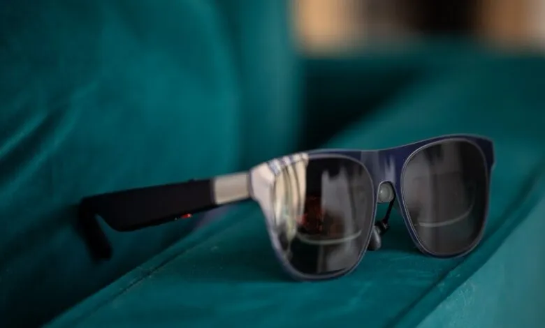 XREAL Air 1S AR glasses on a teal velvet surface, close-up.