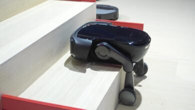 Roborock robot vacuum climbing stairs with wheeled legs.