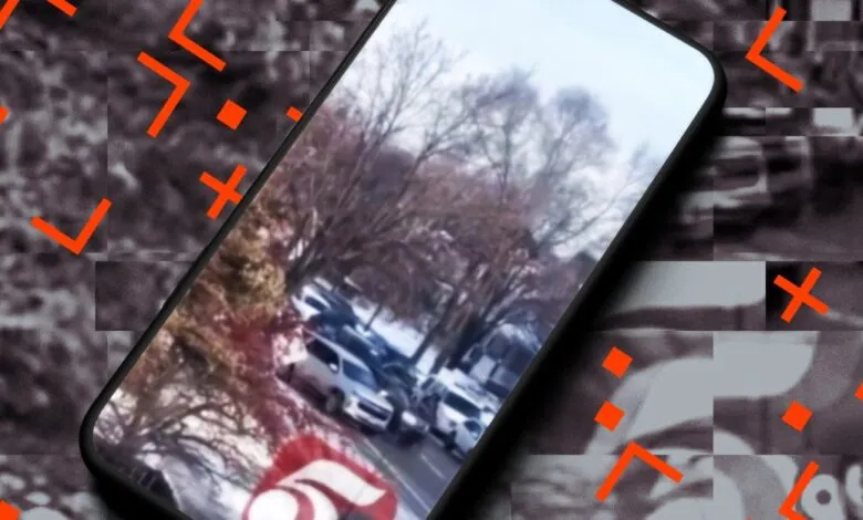 Smartphone displays a video of cars on a snowy street with bare trees.