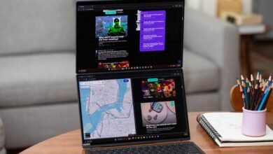 Asus Zenbook Duo laptop with dual screens displaying web content.