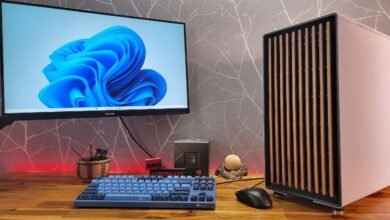 Desktop setup with monitor, custom PC, keyboard, and accessories.