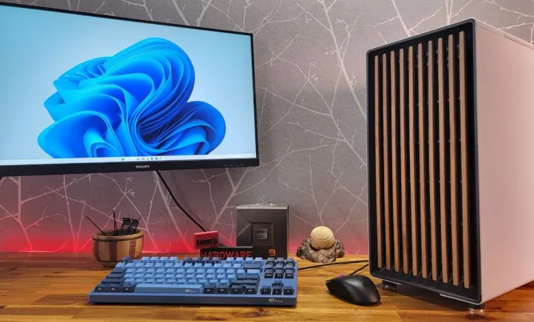 Desktop setup with monitor, custom PC, keyboard, and accessories.