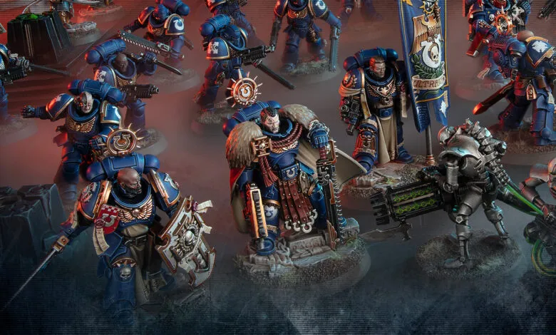 Warhammer 40k Ultramarines miniatures in blue armor, ready for battle.