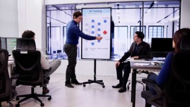 Man presents AI training diagram to colleagues in modern office setting.