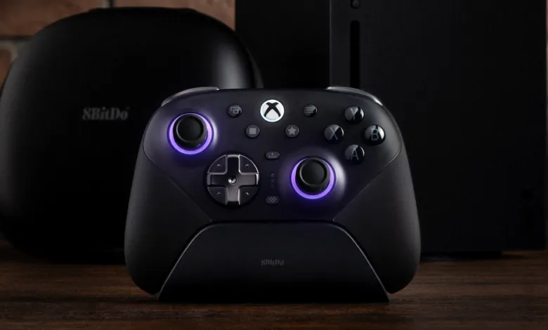 8BitDo Ultimate Controller on charging dock with Xbox console and case.