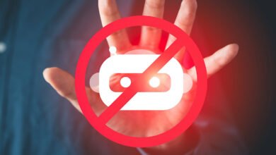 Hand with red 'no' symbol over robot icon, representing AI ban.