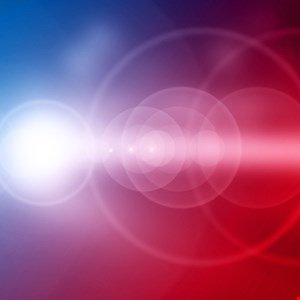 Abstract background with blue and red gradients and lens flare effects.