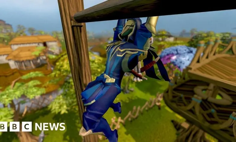 Runescape character hanging from wooden structure in game world.