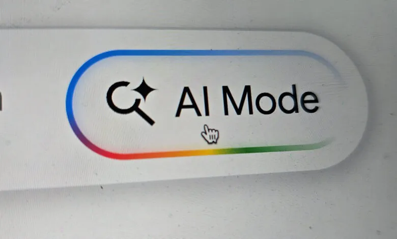 AI Mode button on a screen with a magnifying glass icon and rainbow progress bar.