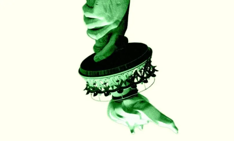 Two hands holding a decorative object with intricate details.