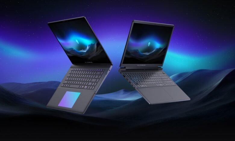 Two Alienware laptops floating against a starry, aurora-filled sky.