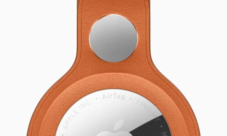 Close-up of an orange Apple AirTag FineWoven Key Ring.