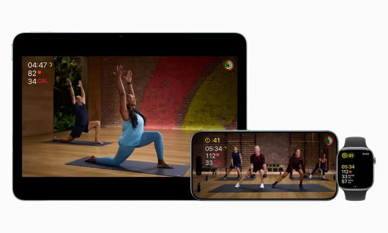 Apple Fitness Plus displayed on iPad, iPhone, and Watch showing workout metrics.