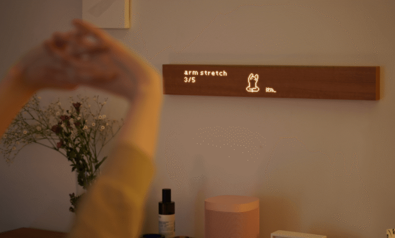 Person doing arm stretches guided by a digital display on the wall.