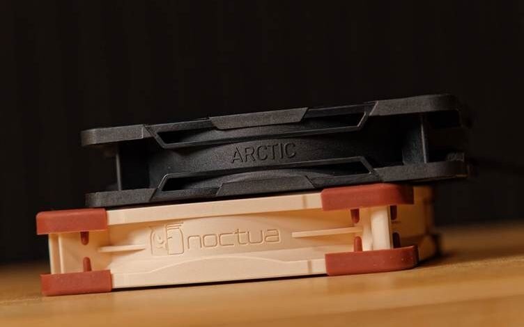Two computer fans stacked: Arctic on top of Noctua.