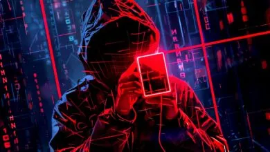 Person in hoodie holds glowing card against a digital background.
