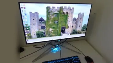 Gaming monitor displays a castle scene with keyboard and mouse.