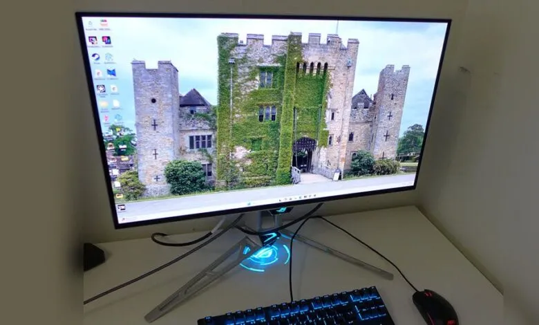 Gaming monitor displays a castle scene with keyboard and mouse.