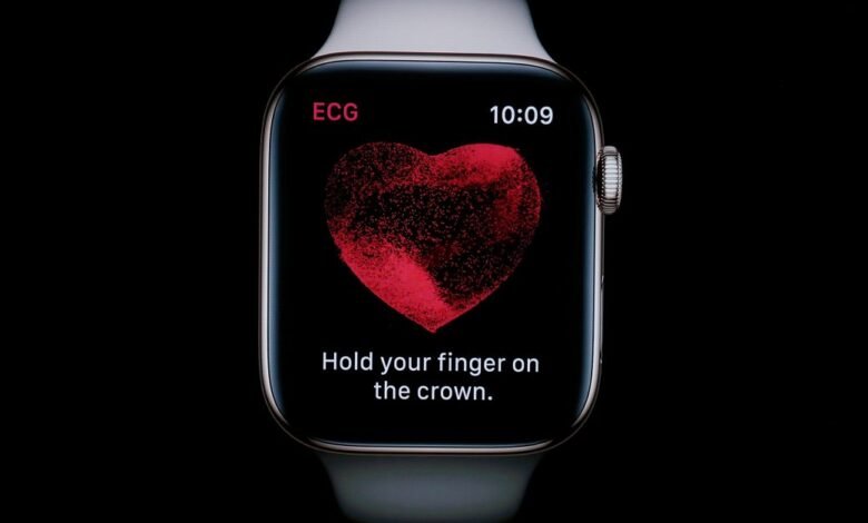 Apple Watch displaying ECG app with heart graphic and instruction.