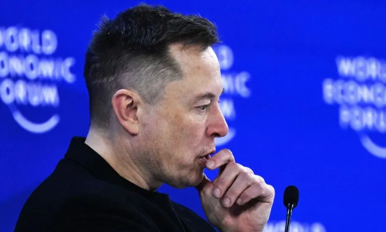 Elon Musk at the World Economic Forum, looking thoughtful.