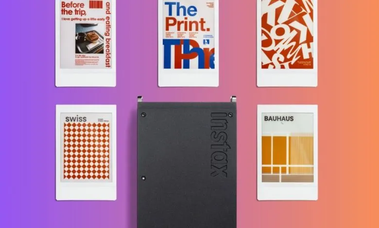 Instax printer surrounded by instant prints with graphic designs.
