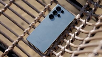 Samsung Galaxy phone with prominent camera lenses resting on woven chair.