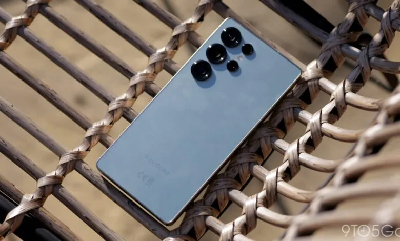 Samsung Galaxy phone with prominent camera lenses resting on woven chair.