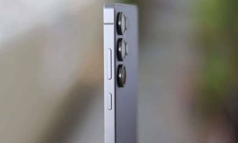 Side view of a silver smartphone with camera lenses and buttons.