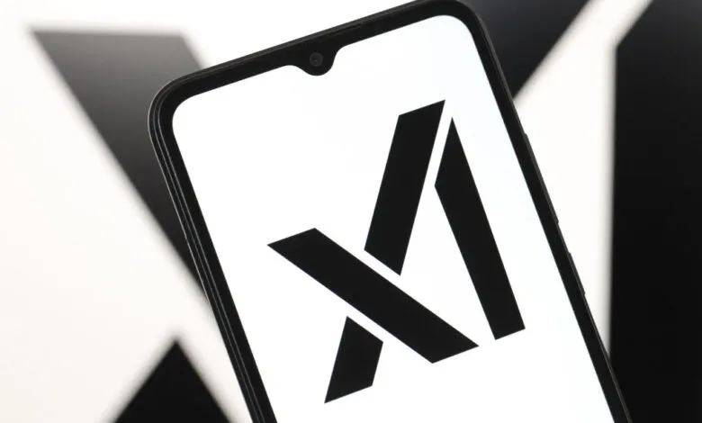 Smartphone displays the xAI logo, a stylized 'X' and 'A' in black on white.