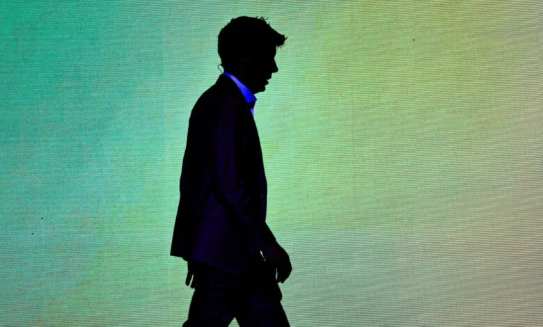 Silhouette of Sam Altman walking against a textured green backdrop.