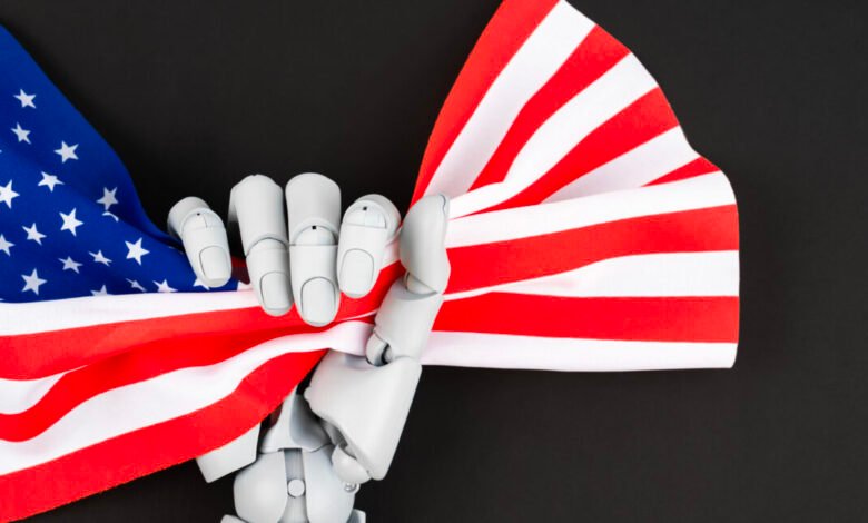 Robot hand holds American flag against a black background.