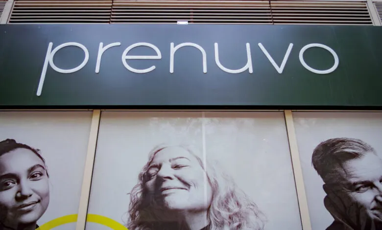 Prenuvo clinic entrance with sign and portraits of diverse people.