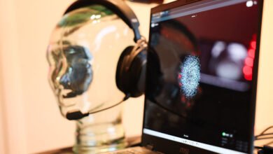 Brain-computer interface headset displayed with brainwave activity on laptop.