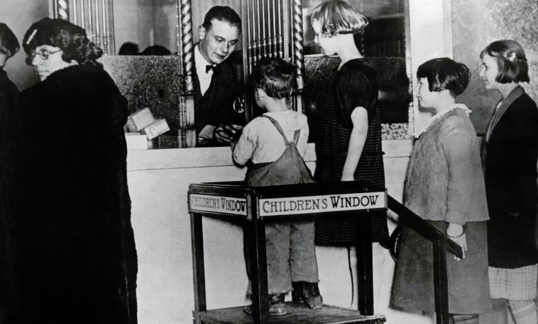 Children at a bank teller window designed for kids in 1925.