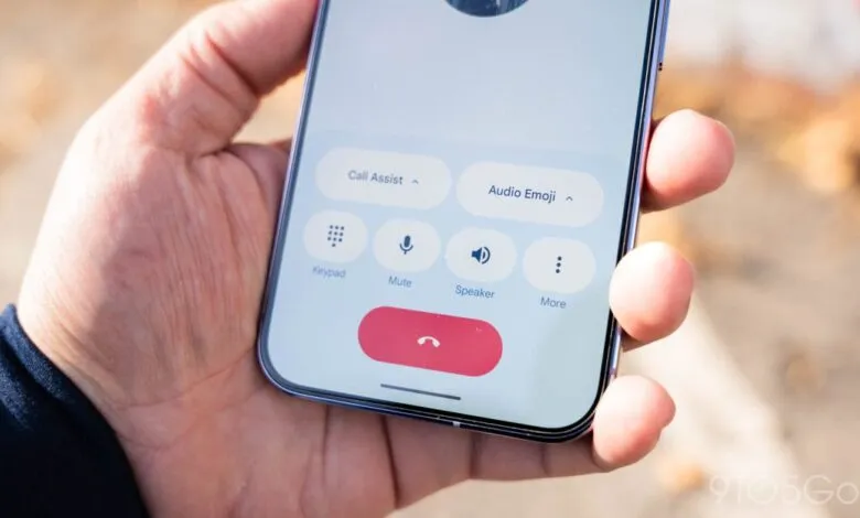 Hand holding phone displaying Google Phone app call screen.