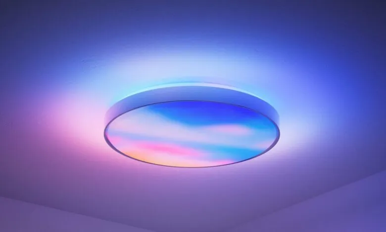 Round ceiling light with sky design and colorful ambient lighting.