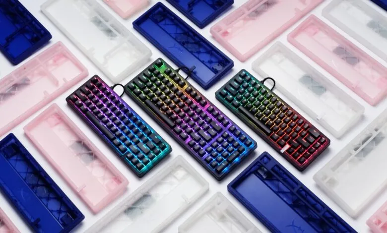 Several HyperX Origins 2 keyboards with colorful LED lighting and cases.
