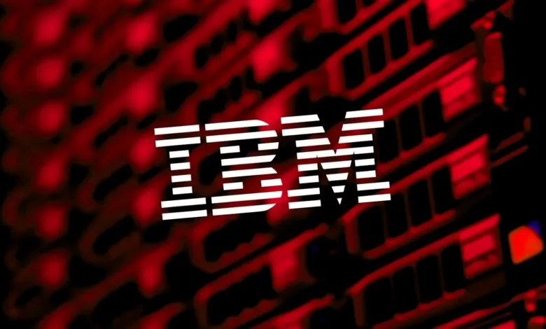 IBM logo in white against a blurred red and black background.