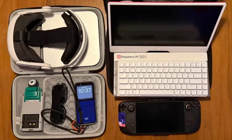 VR headset, Raspberry Pi, Steam Deck, and phone arranged on a wooden surface.