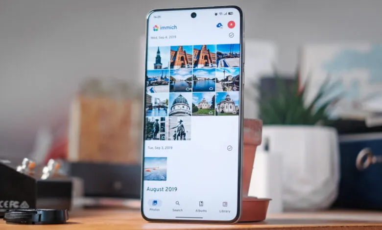 Smartphone displaying Immich app gallery with photos from August/September 2019.