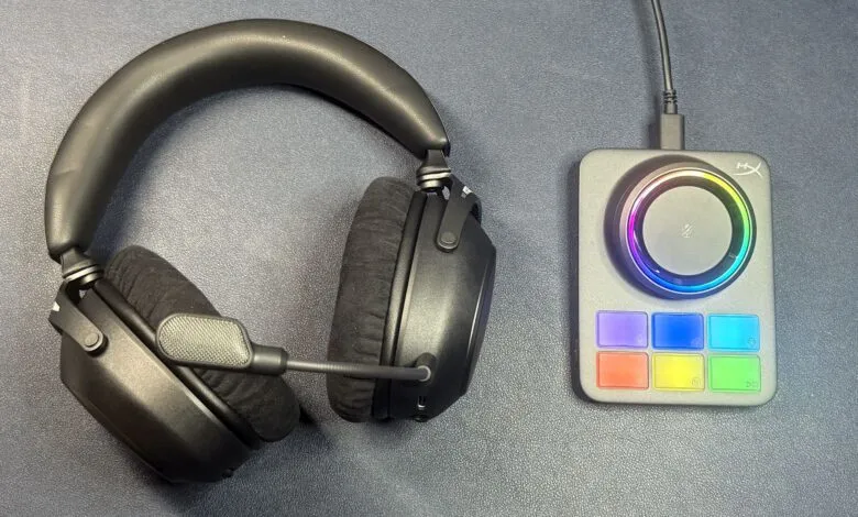 Black HyperX gaming headset and audio mixer on a dark surface.