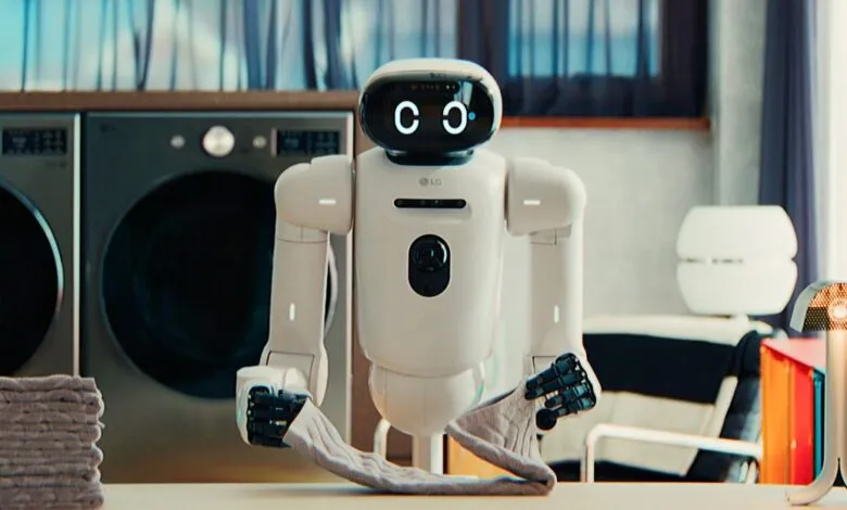 LG CLOi GuideBot folding laundry, with a friendly digital face.