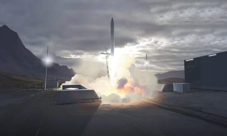 Rocket launching from a site with mountains and a cloudy sky in the background.