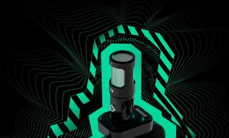 Shure MV88 microphone on stand with green geometric background.