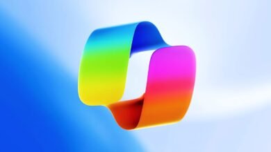 Abstract ribbon loop with vibrant rainbow gradient on blue background.