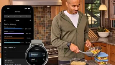 Man cooking with nutrition app on phone and watch displaying calorie counts.