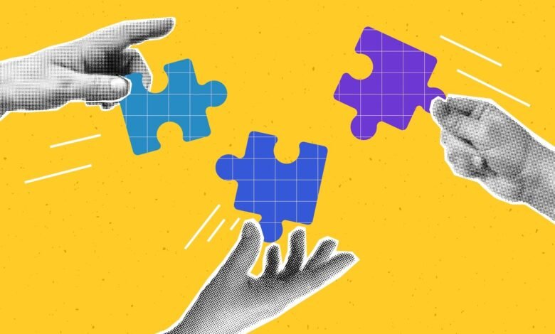 Hands connect puzzle pieces on yellow background, symbolizing teamwork.