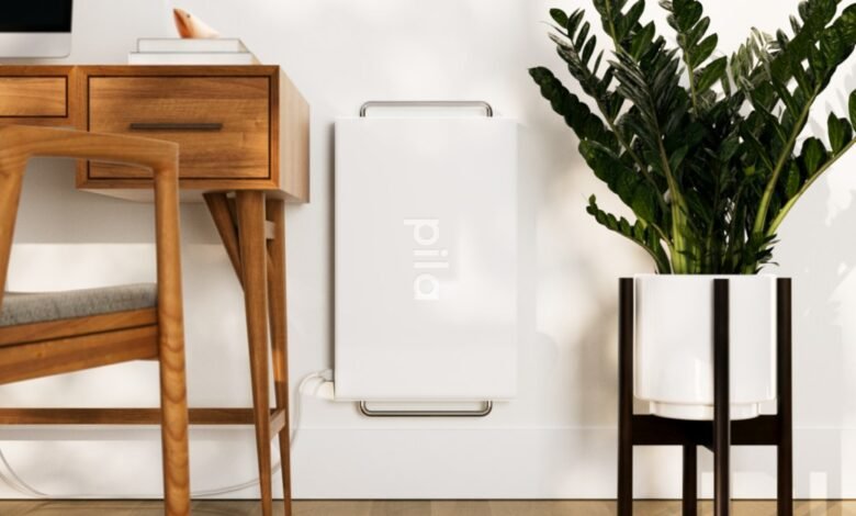 Pila home battery mounted on wall in modern office setting.